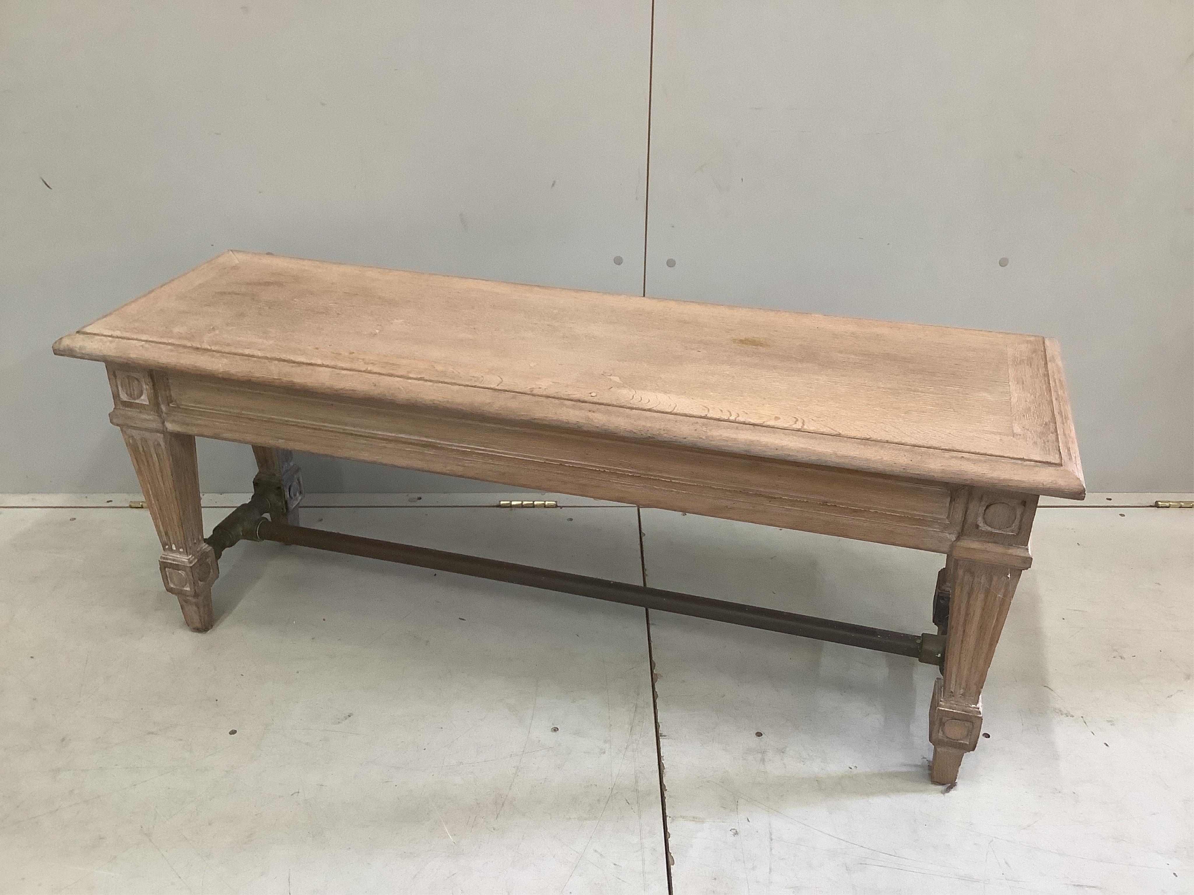 A modern limed oak window seat with industrial style brass stretcher, width 125cm, depth 40cm, height 50cm